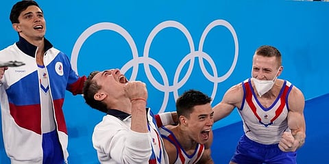 ROC's artistic gymnastics team, from right, Denis Abliazin (R), Nikita Nagornyy, David Belyavskiy & Artur Dalaloyan celebrate after winning the gold medal at the 2020 Olympics. (Photo | AP)