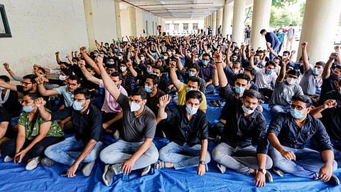 Resident doctors shout slogans during a strike regarding their demands. (Photo | PTI)