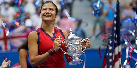Emma Raducanu holds up the championship trophy after defeating Leylah Fernandez during the women's singles final of the US Open tennis championships in New York. (Photo | AP)