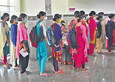 Nursing students stand in a queue to get themselves immunised against Covid-19 at New Government General Hospital in Vijayawada. (File photo | EPS/P Ravindra Babu)