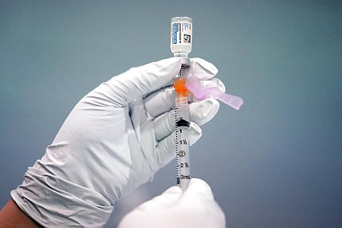 A member of the Philadelphia Fire Department prepares a dose of the Johnson & Johnson COVID-19 vaccine at a vaccination site setup in Philadelphia. (Photo | AP)