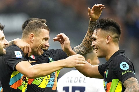 Inter Milan's Edin Dzeko, left, celebrates after scoring with teammate Lautaro Martinez during Serie A match against Bologna, at San Siro stadium in Milan, Italy, Saturday. (Photo | AP)