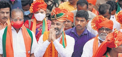 BJP State president Bandi Sanjay greets people on the fourth day of his Praja Sangrama Yatra at Chilkur X roads. (File photo | Express)