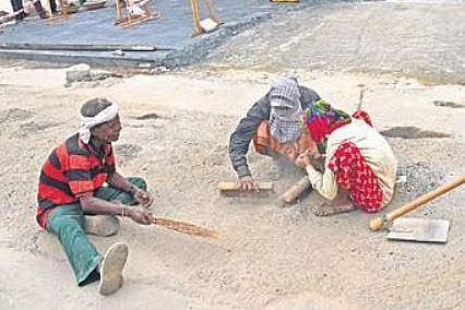 Workers repair the road outside  #1 Race View Cottage in Bengaluru  on Wednesday | vinod kumar t