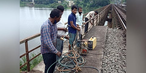 Ongoing repair work on the 242-meter-long rail walkway created in 1981. Though worn down, it has been helping people of the area reach the mainland easily. (Photo | Express)