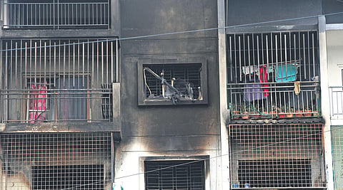 The apartment building in Devarachikkanahalli lies deserted a day after a massive fire claimed two lives. Inset: A team of forensic experts inspect the flats on Wednesday  | Ashishkrishna HP