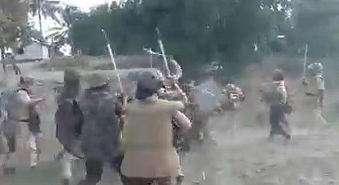 Screengrab of cops clashing with the encroachers at Dholpur in Darrang district of Assam. (Photo | Twitter)