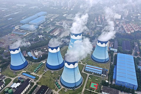 Steam billows out of the cooling towers at a coal-fired power station in Nanjing in east China's Jiangsu province. (Photo | AP)