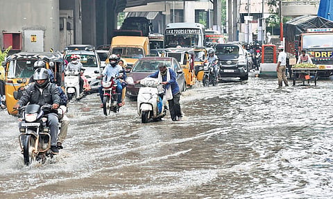 Vehicles wade through a flooded road near Khairatabad Metro Station as sewage water overflows from a drain after  heavy rainfall in the city | S Senbagapandiyan