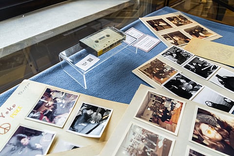 FILE - In this Friday, Sept. 24, 2021 file photo, aview of photos and a cassette with the recording of four Danish schoolboys' interviews with John Lennon and Yoko Ono. (Photo | AP)