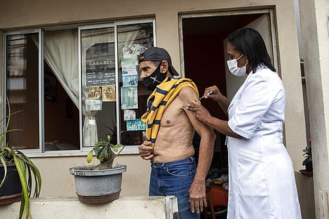 Andre Luiz da Silva, 70, is injected with a dose of Pfizer vaccine during a third dose campaign for elderly residents in Rio de Janeiro, Brazil, Sept. 1, 2021.  (Photo | AP)