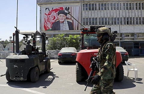 A Taliban soldier patrols at Hamid Karzai International Airport in Kabul, Afghanistan, Sunday, Sept. 5, 2021. (Photo | AP)