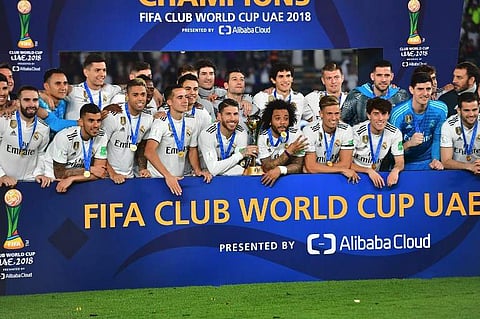Real Madrid's players celebrate with the trophy after winning the FIFA Club World Cup final football match Spain's Real Madrid vs Abu Dhabi's Al Ain at the Zayed Sports City Stadium in Abu Dhabi. (Pho