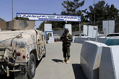A Taliban soldier stands guard at the gate of Hamid Karzai International Airport in Kabul, Afghanistan, Sunday, Sept. 5, 2021.  (Photo | AP)