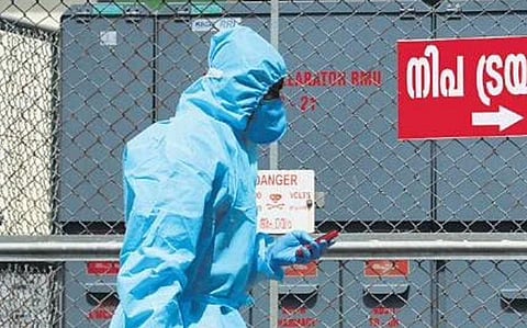 A man passes by the Nipah triage area at the Kozhikoae MCH. 