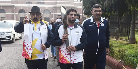 Olympic Silver medalist Ravi Dahiya with the Queens Baton for the Birmingham Commonwealth games at Dhyan Chand National Stadium in New Delhi. (Photo| Parveen Negi, EPS)