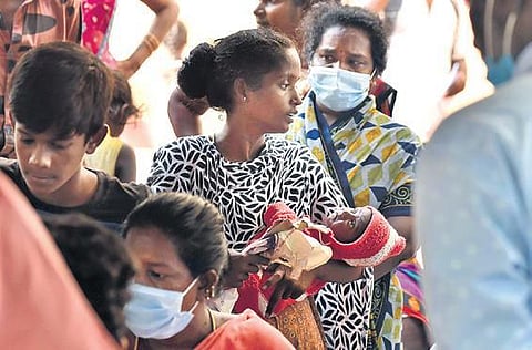 A woman waits for her allotment of housing unit by the TNUHDB at KP Park in Pulianthope,  in Chennai on Tuesday  | P Jawahar
