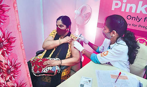 A health worker administers booster dose to a beneficiary at Malleswaram  in Bengaluru on Monday. (Photo | Shriram BN/EPS)
