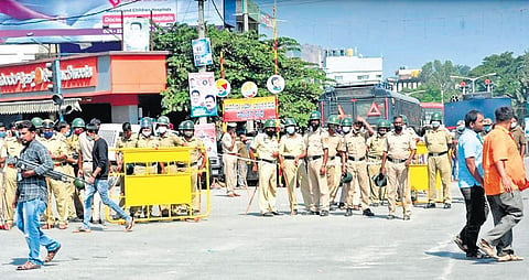 Police personnel stand guard in Ramanagara on Thursday after the Congress called off its Mekedatu padayatra  | Express