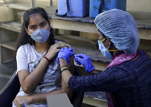 A teenager receives her first dose of vaccine for COVID-19 at a college in Mumbai, India, Saturday, Jan. 15, 2022.  (Photo | AP)