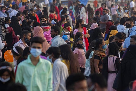 Indians, mostly wearing face masks to help curb the spread of the coronavirus, gather at Juhu beach before they were asked to leave by authorities. (Photo | AP)