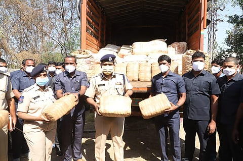 Special Operations Team (SOT) of Cyberabad police with the seized consignments of ganja. (Photo | Express)