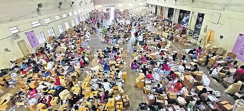 Workers pack Covid isolation kits at  the Victory Playground Indoor Stadium in Hyderabad on Friday | R V K Rao