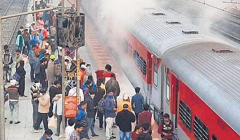 Passengers disembark as smoke emanates from the wheels of the Visakhapatnam-Delhi AP Express in Warangal district on Friday.