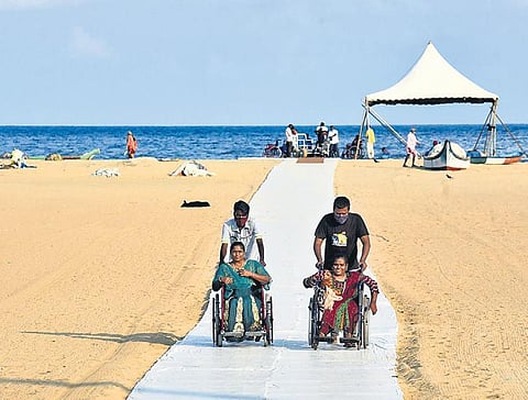 The temporary ramp put up by GCC being used by the disabled  at Marina beach, in Chennai.  (Photo | Martin Louis, EPS)