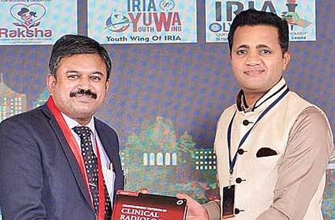 Dr KR Vijaykumar (right) receiving a copy of the ‘Comprehensive Textbook of Clinical Radiology’ at a function organised by National Indian Radiological and Imaging Association in city