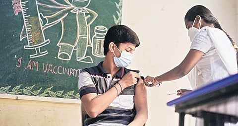 A health worker inoculates a boy against Covid-19 during a vaccination drive for students of private schools at Mylapore, in Chennai on Saturday. (Photo | R Satish Babu/EPS)