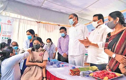 On the first day of administering Covid vaccines to persons in the 15-18 age group, Health Minister T Harish Rao watches as 15-year-old Vaishnavi receives her jab at Banjara Hills UPHC, Jan 3, 2022.