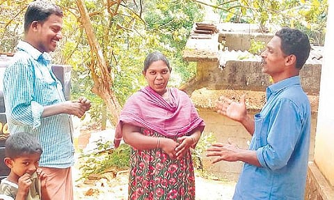 Manoj O M, right, new mooppan of Manakka-yam, interacts with a family | SHAJI VETTIPURAM
