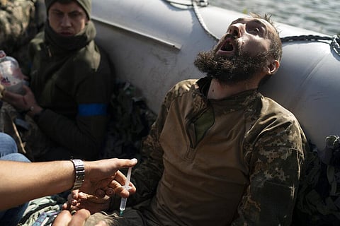 A Ukrainian soldier reacts as he receives an injection during an evacuation of injured soldiers participating in the counteroffensive,  near the retaken village of Shchurove, Ukraine. (Photo | AP)