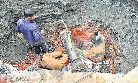 Repair work underway of the Cauvery water pipe which burst, resulting in a gaping sinkhole at Kundalahalli Junction on Sunday | Express