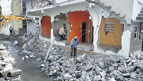 BBMP workers continue with their demolition drive, clearing the encroachment of a rajakaluve at S R Layout, K R Puram, in Bengaluru on Tuesday 