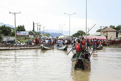 People stranded due to floods following several days of downpours, in Kogi Nigeria, Thursday, Oct. 6, 2022.  (Photo | AP)