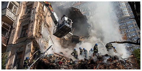 Firefighters work after a drone attack on buildings in Kyiv, Ukraine, on Oct. 17. (Photo | AP)