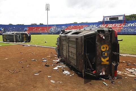 Police cars wrecked in soccer riots are seen on the pitch at Kanjuruhan Stadium in Malang, East Java, Indonesia, Sunday, Oct. 2, 2022. (Photo | AP)