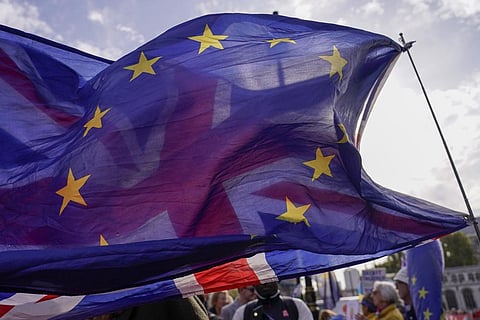 In this representational image, a Union flag waves behind a European Union flag, outside the Houses of Parliament, in London. (Photo | AP)
