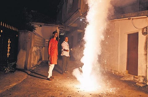 A lit firecracker adds to the already polluted air in Hyderabad on Monday | Vinay Madapu