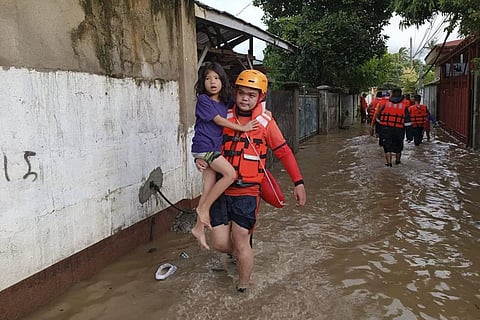 Flash floods and landslides set off by torrential rains left at least 50 people dead, including in a hard-hit southern Philippine province, where as many as 60 villagers are feared missing and buried in a huge mudslide laden with rocks, trees, and debris.
