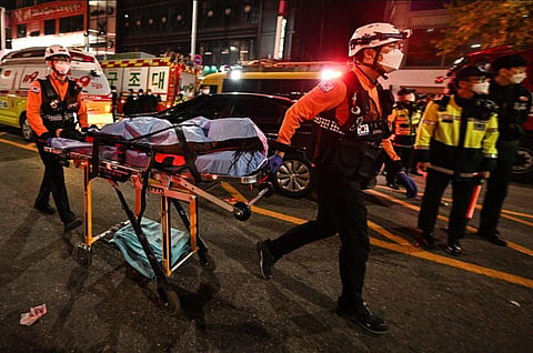 The body of a victim is transported out of the district of Itaewon in the capital, Seoul after a deadly stampede. (Photo | AFP)