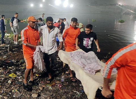 National Disaster Response Force (NDRF) personnel conduct rescue operations after a cable bridge collapsed in the Machchhu river, in Gujarat's Morbi on October 30, 2022. (Photo | ANI)