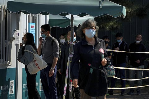Residents line up to get their routine COVID-19 throat swabs at a coronavirus testing site in Beijing. (Photo | AP)