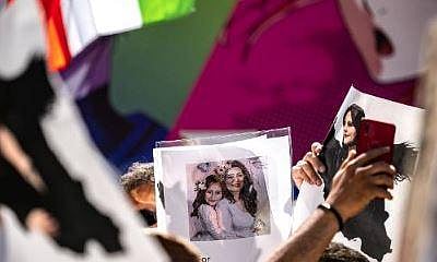 People chant slogans and hold pictures of Mahsa Amini during the 'Freedom rally for Iran' event in the Shibuya district of Tokyo on October 1, 2022. (File Photo | AFP)