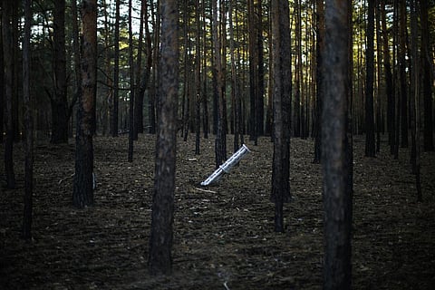 A Russian rocket sticks out of the ground in a forest near Oleksandrivka village, Ukraine. (Photo | AP)