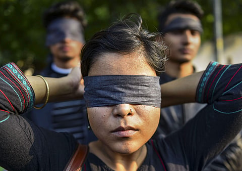 In this backdated image, women blindfold during a protest to highlight the issue of violence against women in the country in New Delhi. (File Photo | PTI)