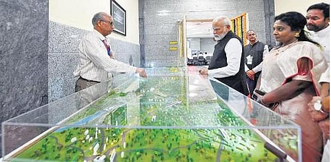 PM Narendra Modi at Ramagundam Fertilizers and Chemicals Corporation Ltd on Saturday. Governor Tamilisai looks on  ​