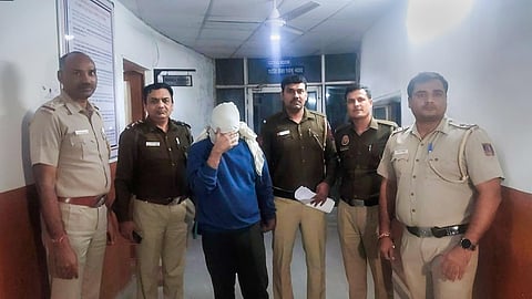 Police personnel along with accused Aaftab Ameen Poonawala pose for the media, at Mehrauli Police Station, in New Delhi. (Photo | PTI)